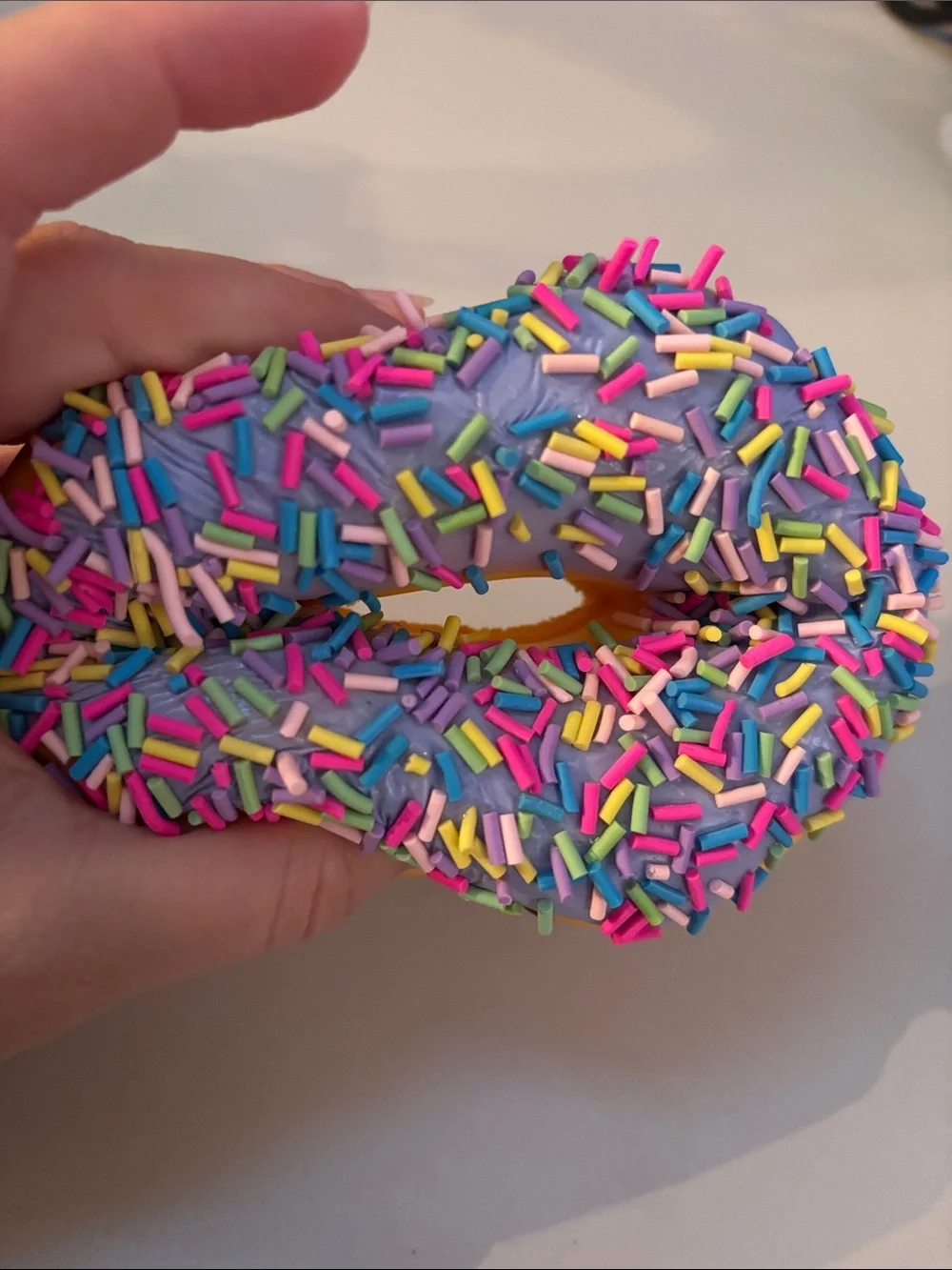 Smiling Yellow Donut Plush Toy with Purple Frosting and Rainbow Sprinkles